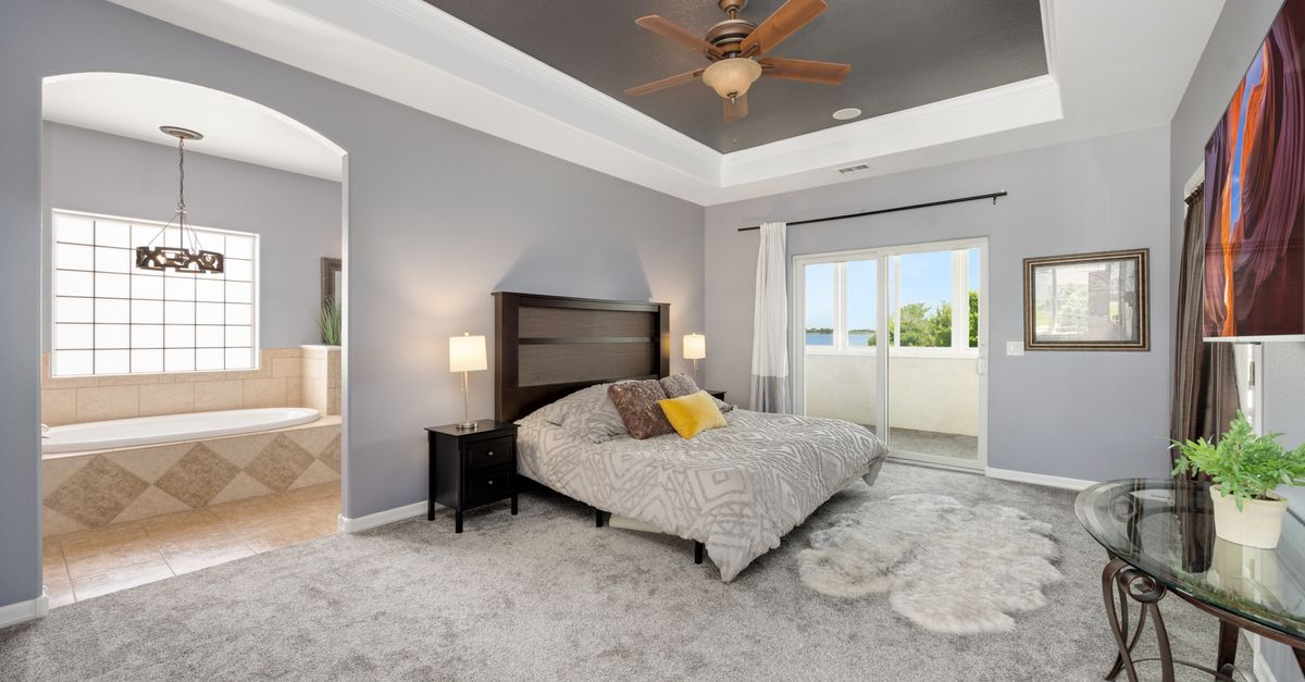 Spacious modern bedroom with stylish decor and natural light. Ideal for contemporary living.
