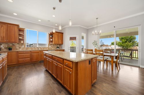 Free Bright and spacious kitchen with wooden cabinets and a dining area. Stock Photo