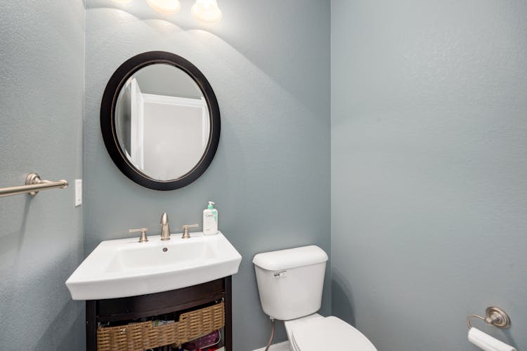 Mirror, Washbasin And Toilet In Bathroom