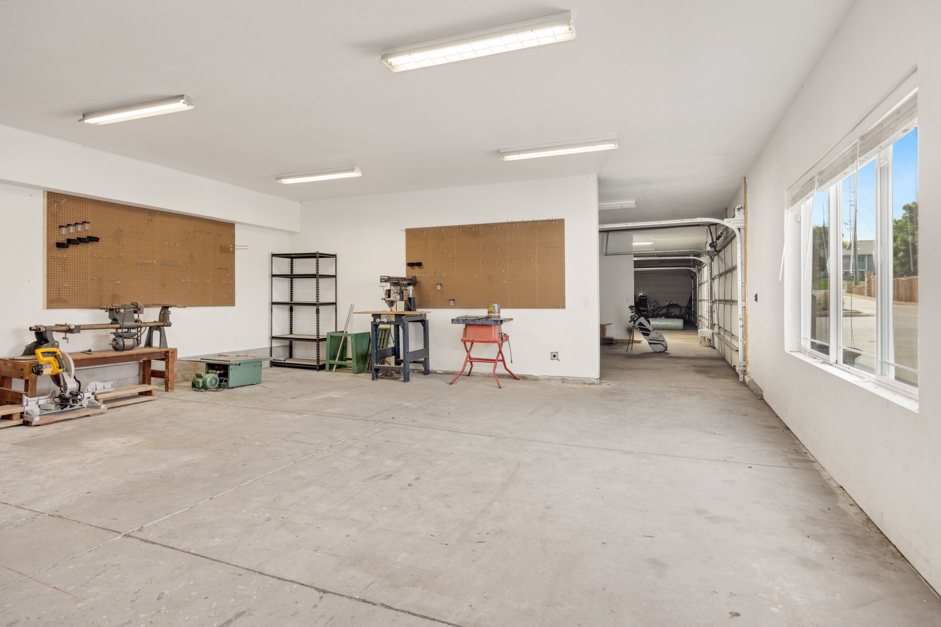 elegant garage transformation for beginners A bright and spacious industrial workshop with machinery and tools.