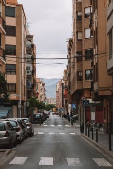 Explore a typical urban street scene in Valencia, capturing local buildings and city life.