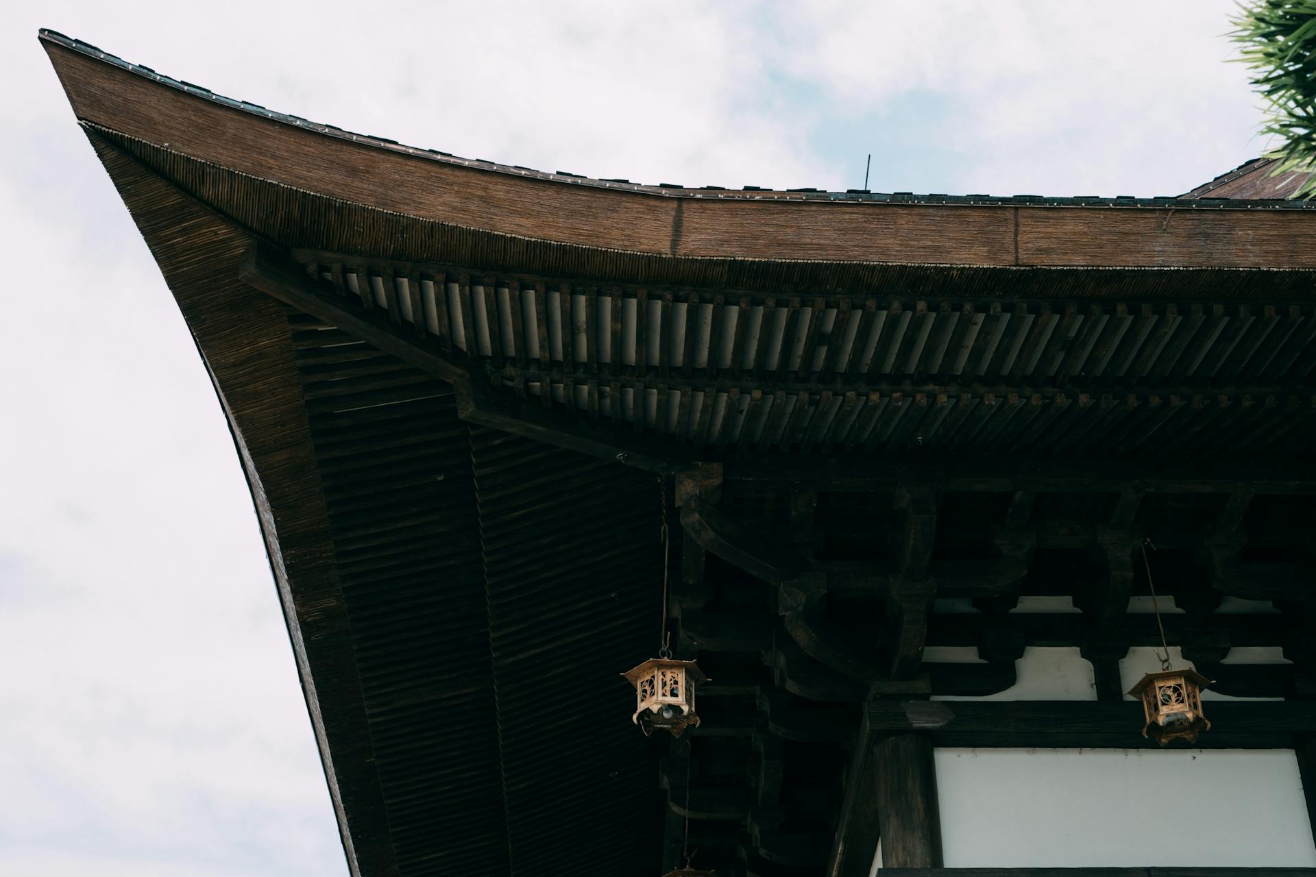 Close-up of a traditional Japanese wooden rooftop showcasing intricate design and cultural heritage.