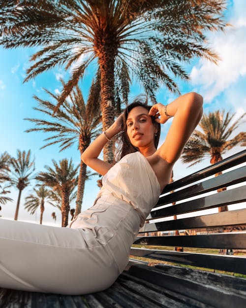 Woman Posing in White Clothes on Bench