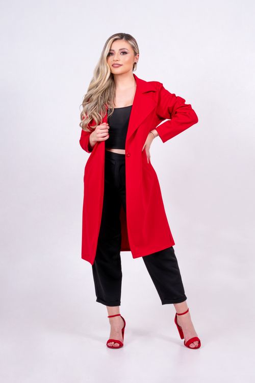 Free Fashionable woman posing in a red coat on a white background, showcasing modern style. Stock Photo