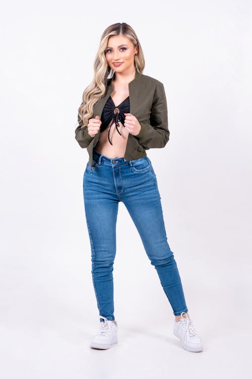 Blonde Woman in Shirt and Jeans Posing in Studio