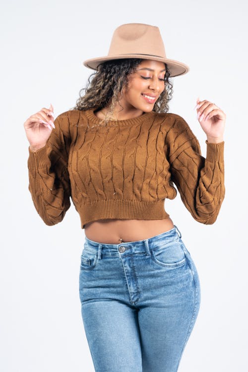 Smiling Model in Brown Sweater and Jeans