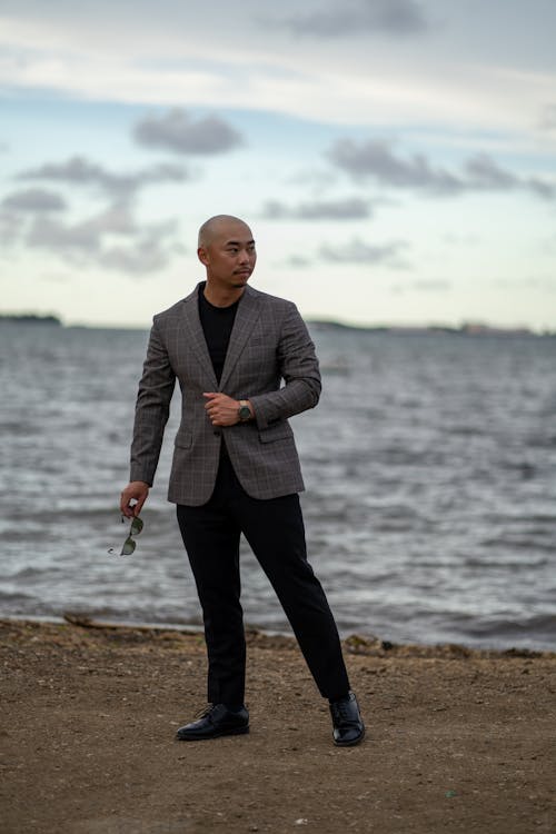 Free Man in Suit Posing on Sea Shore Stock Photo