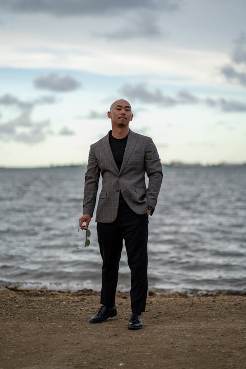 Free Bald Man Posing in Suit on Sea Shore Stock Photo