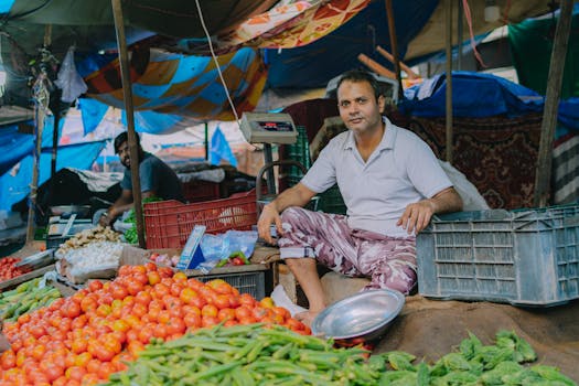 Colorful street market scene featuring a vendor with an array of fresh vegetables.