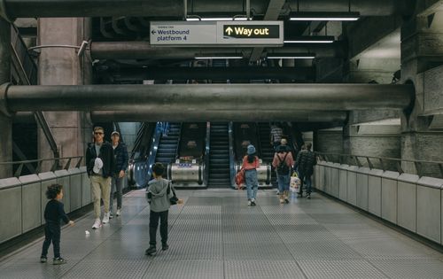 Free Travelers navigating the busy escalators in a London subway station. Stock Photo