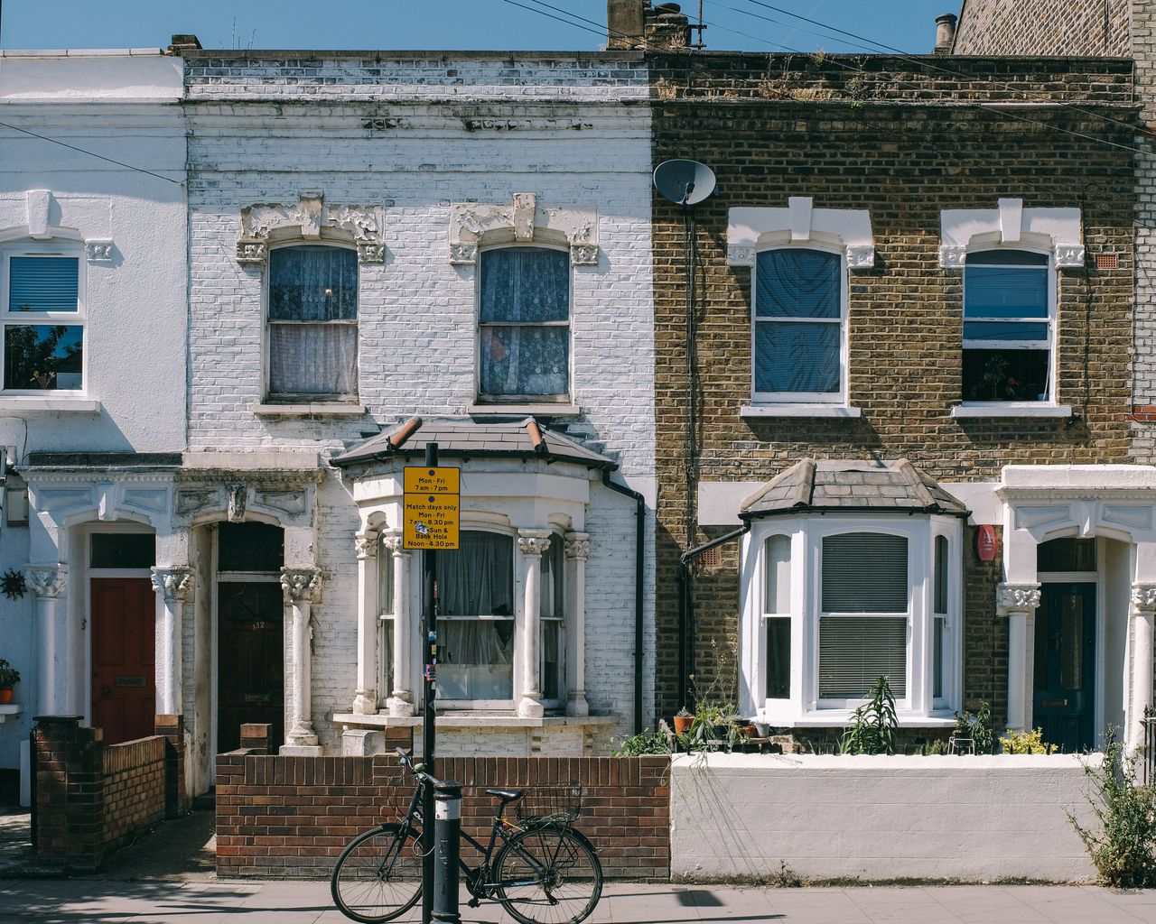 Typical London Victorian terraced houses with bay windows, stock brick and white render