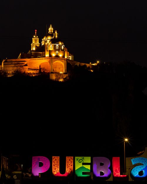 Free Stunning view of Puebla illuminated letters with church at night in Puebla, Mexico. Stock Photo