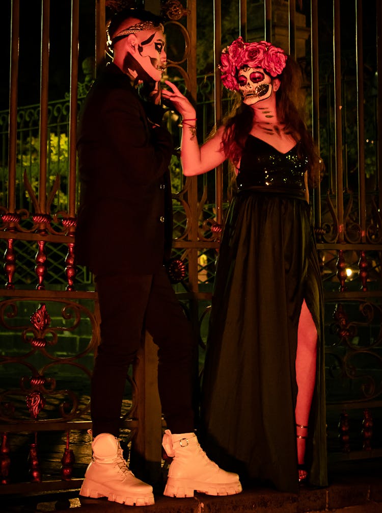 Couple In Costumes For Dia De Muertos At Party