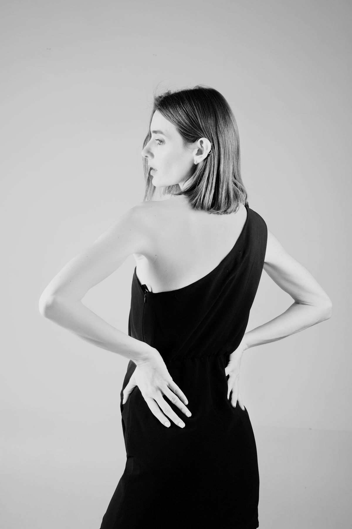 Model in Black Dress Posing with Hands in Hair · Free Stock Photo