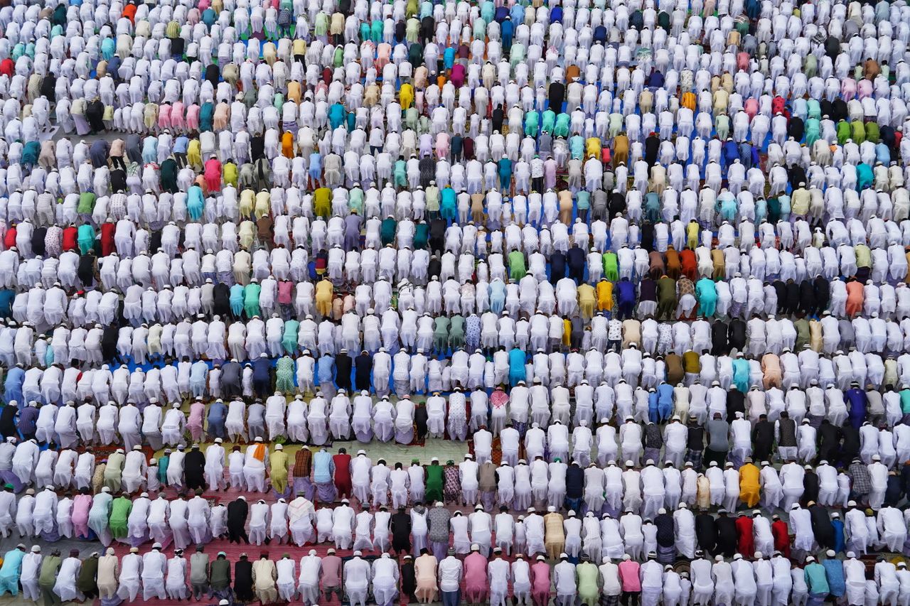 high angle view of a diverse crowd engaging in outdoor prayer showcasi