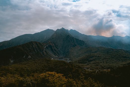 Breathtaking landscape featuring rugged mountains under an overcast sky.