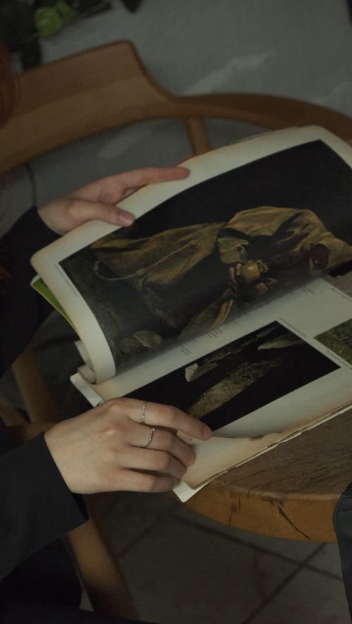 Free Close-up of a woman holding a vintage photo album indoors in Ankara, Türkiye. Stock Photo