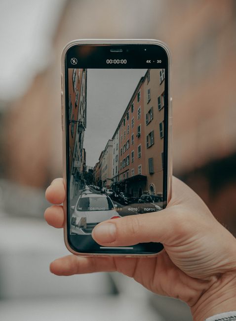 hand holding smartphone recording video