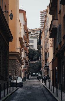 Charming narrow alleyway with tall buildings on both sides, capturing a quiet urban morning.