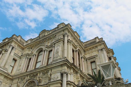 Low angle view of a baroque facade in İstanbul, Türkiye against a blue sky.