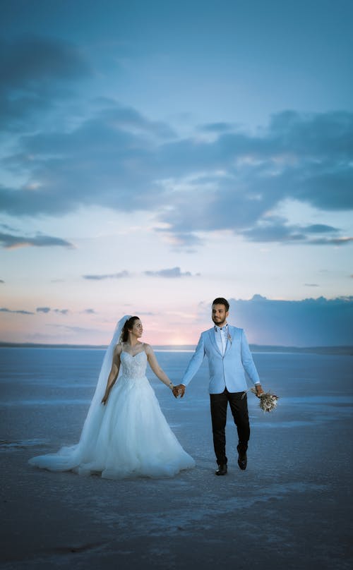 Newlyweds Holding Hands at Dusk