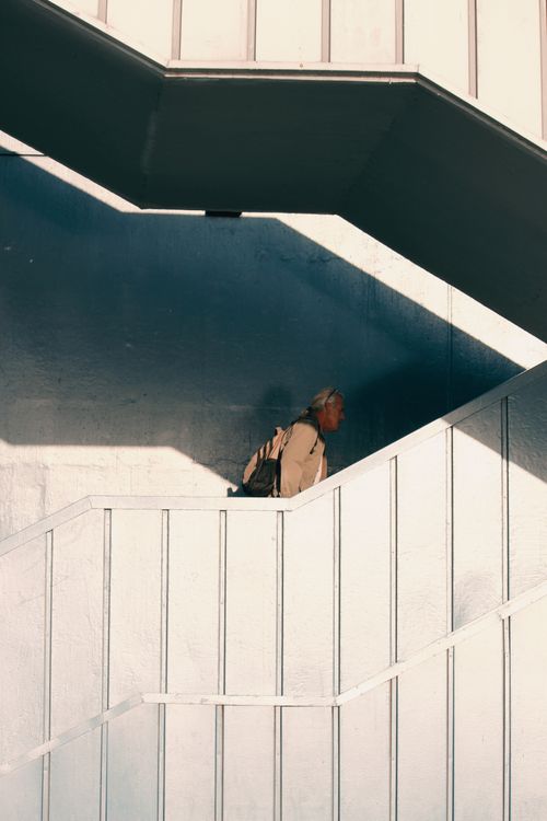 Free A person ascends a modern staircase in Istanbul. Urban architecture at its finest. Stock Photo
