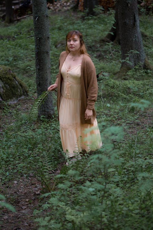Woman in a Dress Walking in a Forest 