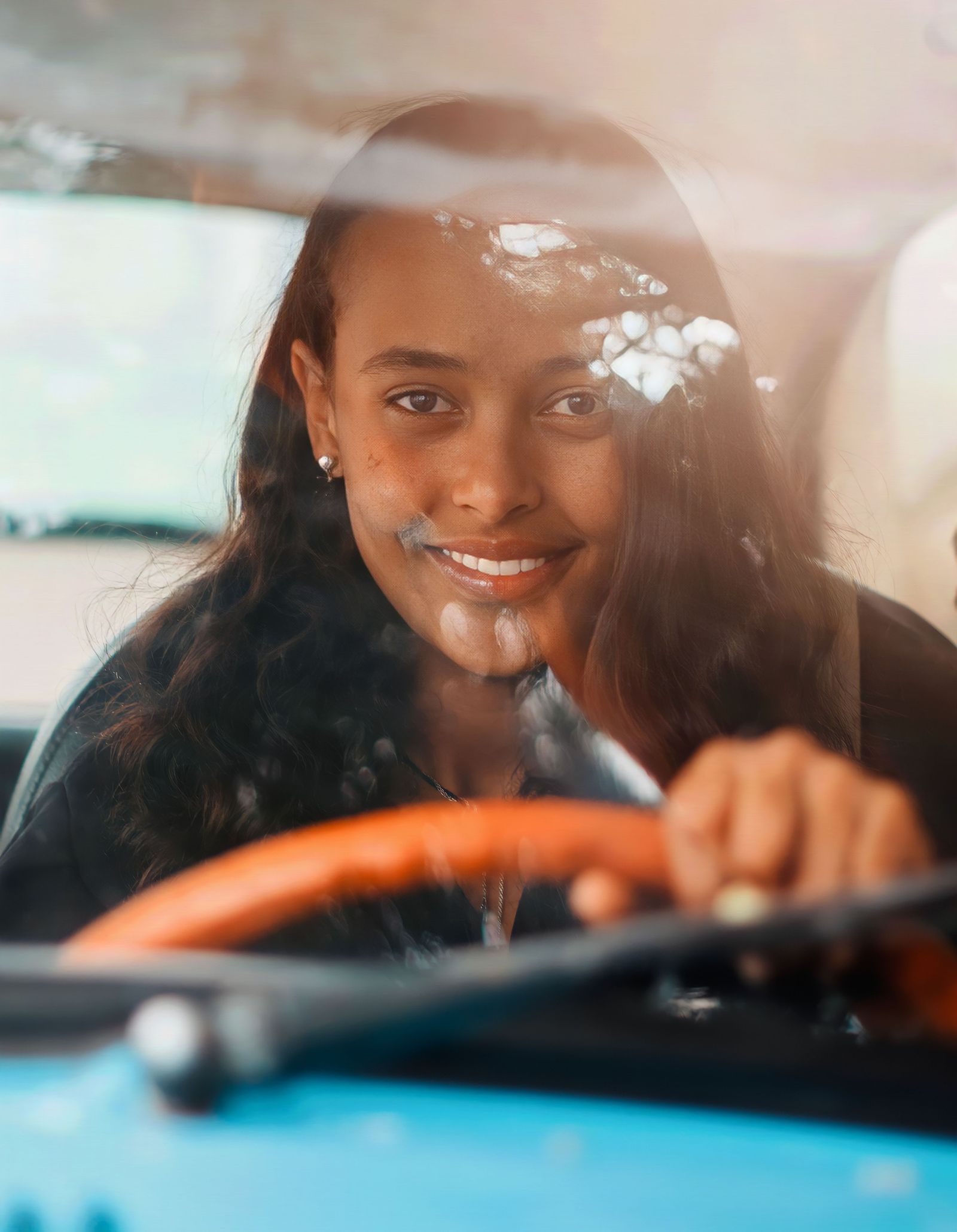 A driver smiling calmly at the wheel