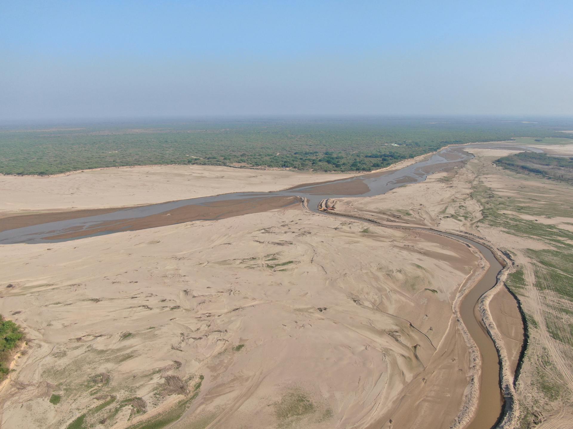 Drone capture showcasing the sandy riverbank and landscape of La Dorada, Paraguay.