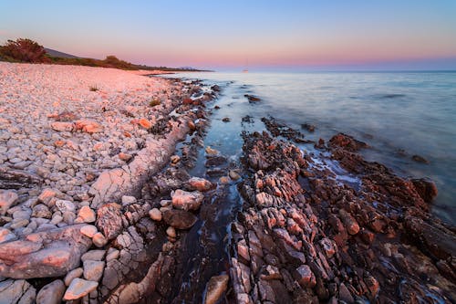 View of a Rocky Beach and Seascape at Sunset
