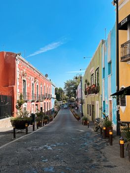 Vibrant street scene capturing colorful buildings in Puebla, Mexico on a clear day.