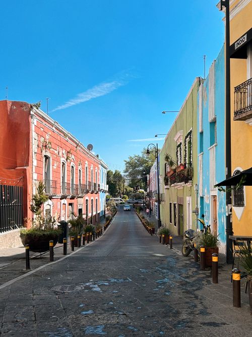 Free Vibrant street scene capturing colorful buildings in Puebla, Mexico on a clear day. Stock Photo