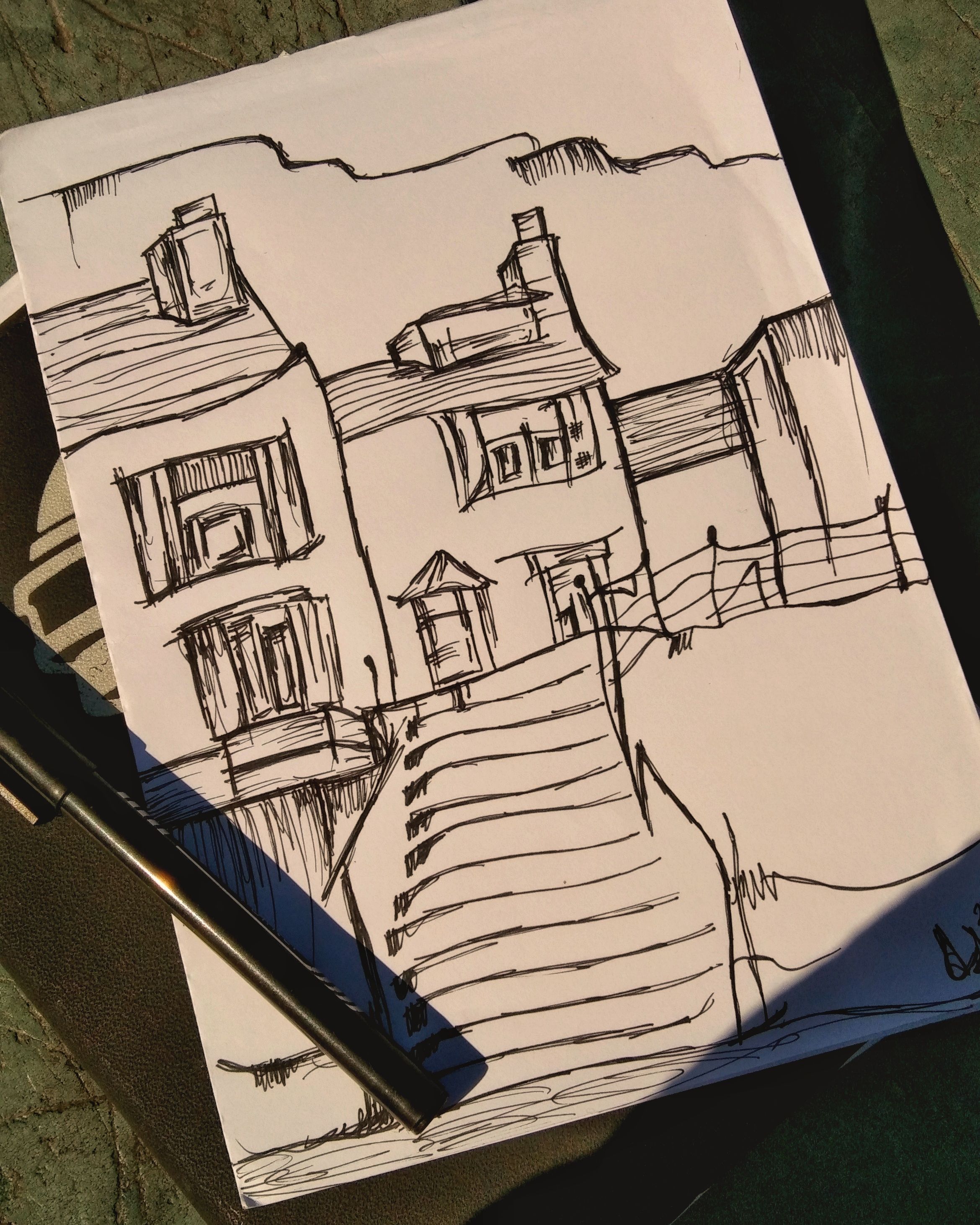 Pen-and-ink drawing of a terraced townscape on warm paper — photo by Ezzah Graphy on Pexels