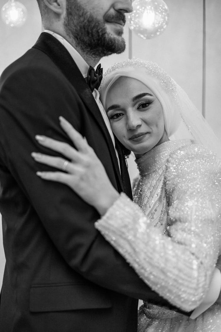 Smiling Bride In Traditional Dress Hugging Groom