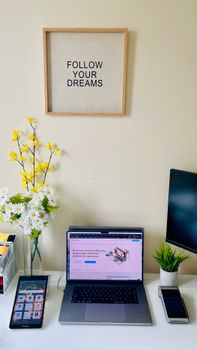 Modern workspace featuring a laptop and motivational decor for productivity.