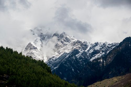 Free Stunning view of snowcapped mountains surrounded by forests in Kullu, Himachal Pradesh, India. Stock Photo