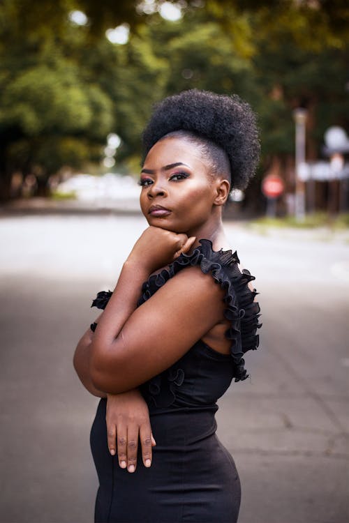 Woman in a Black Dress Posing Outside 