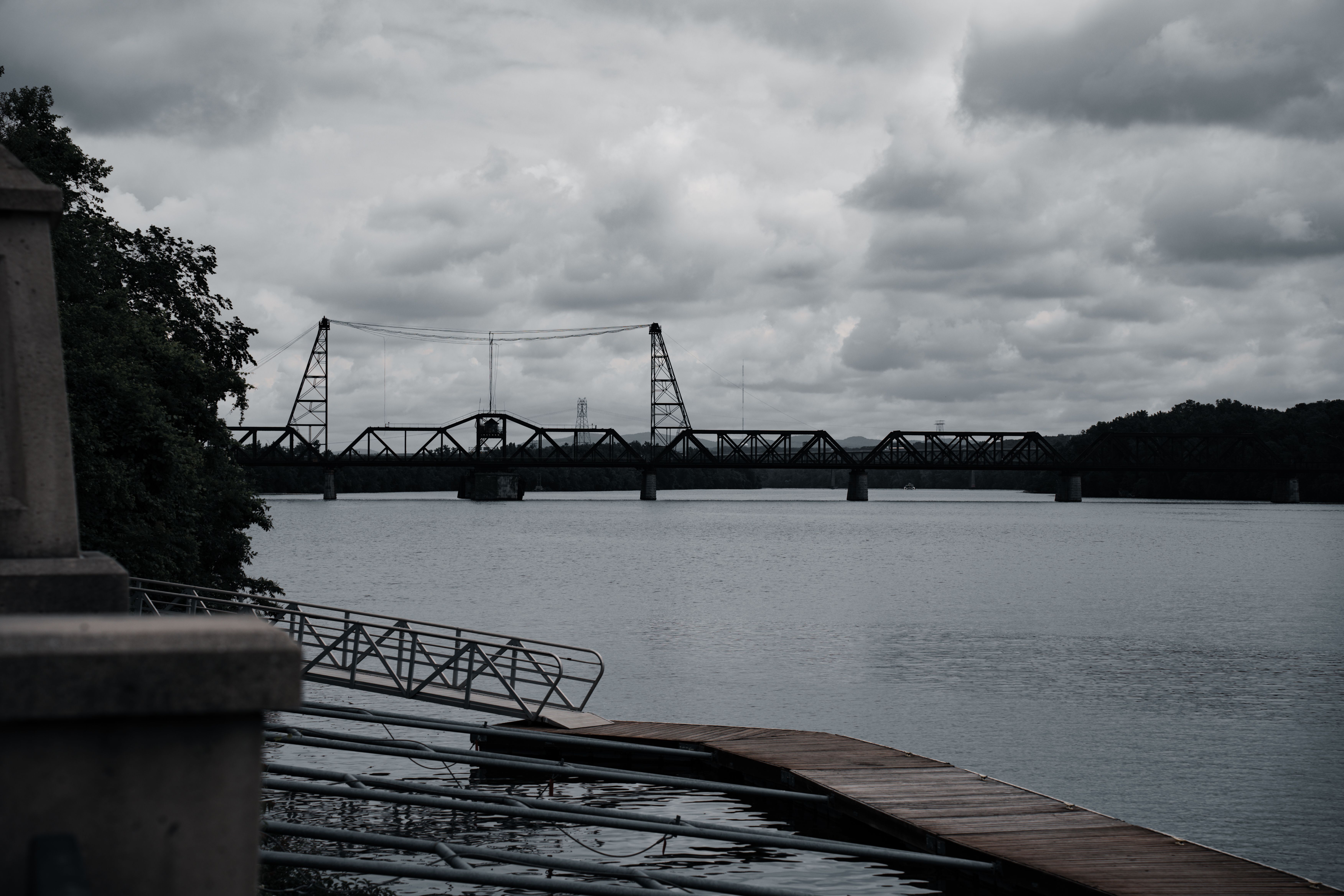 A black and white photo of a bridge over water · Free Stock Photo