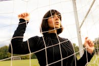 Brunette Woman in Goal Net