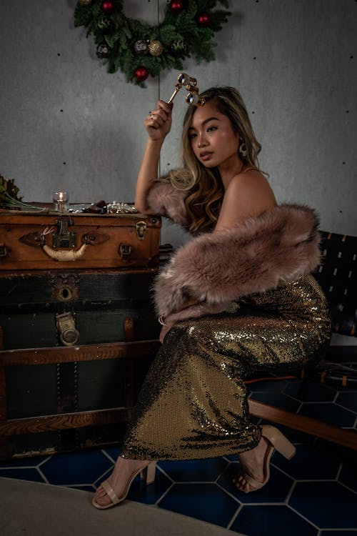 Woman Wearing Long Dress While Sitting On Chair