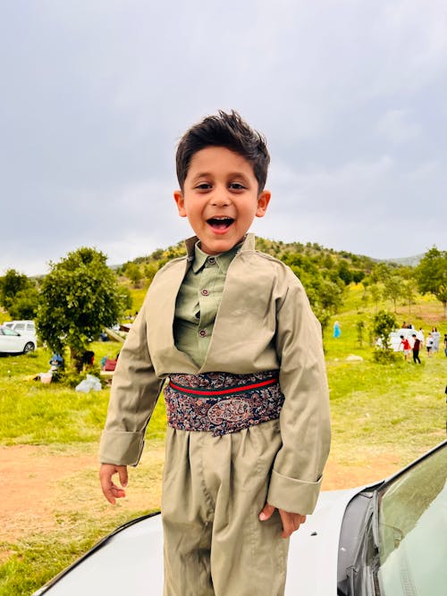 Smiling Boy Posing in Traditional Clothing