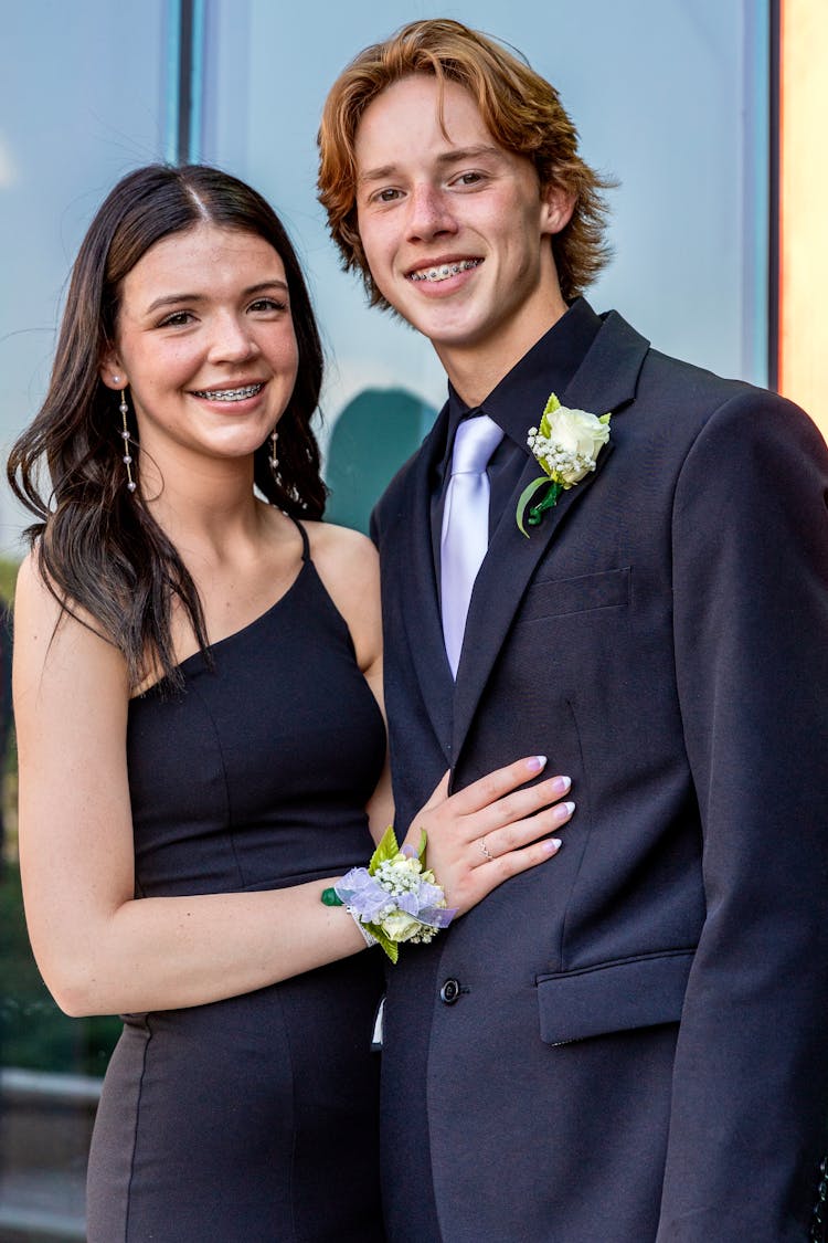 Portrait Of Smiling Couple In Black Dress And Suit