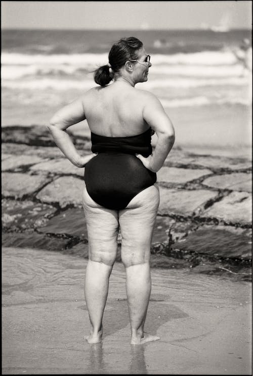 Woman in One-Piece Swimsuit on Beach