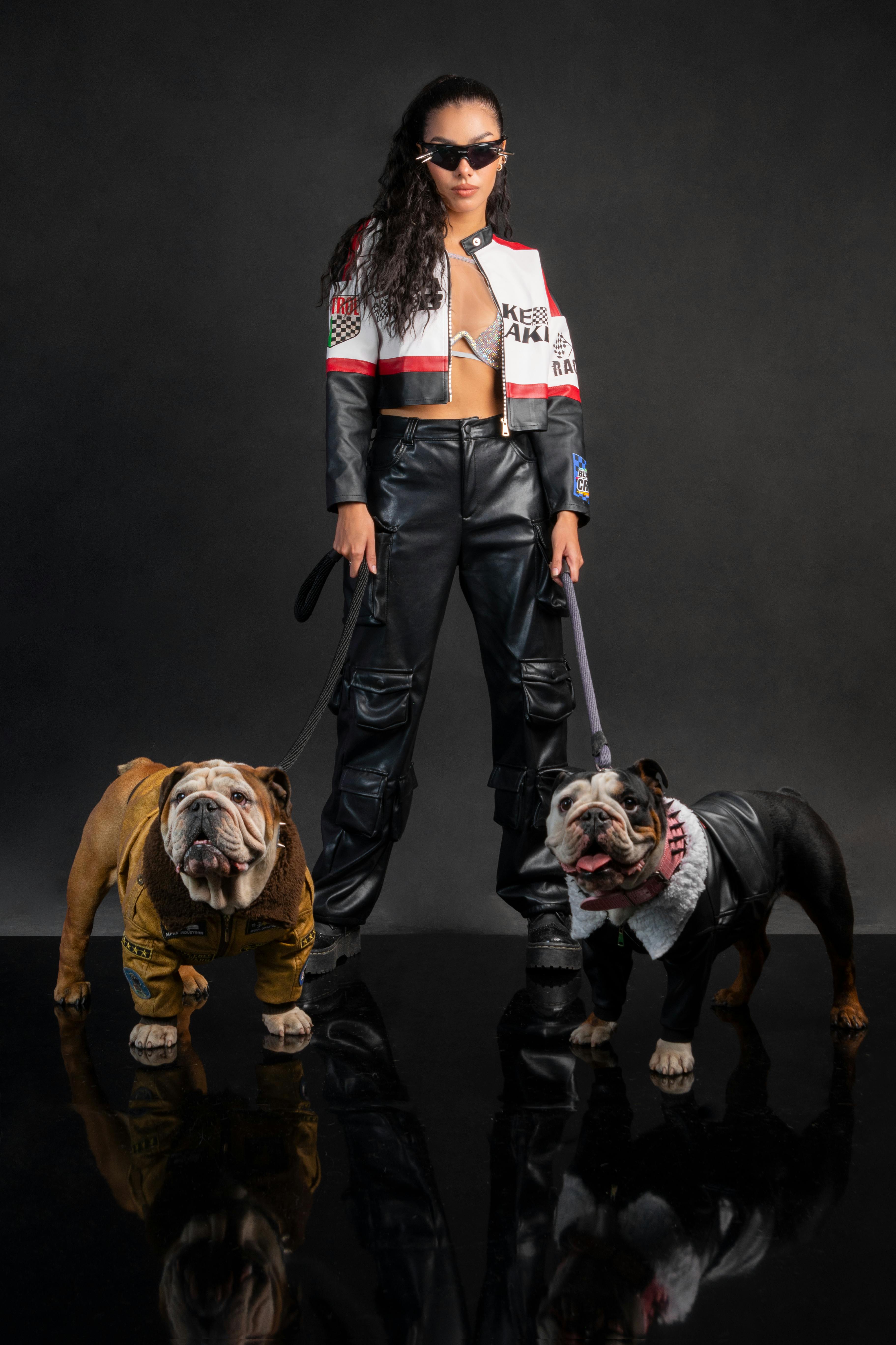 Woman in Racing Suit Standing with Dogs · Free Stock Photo