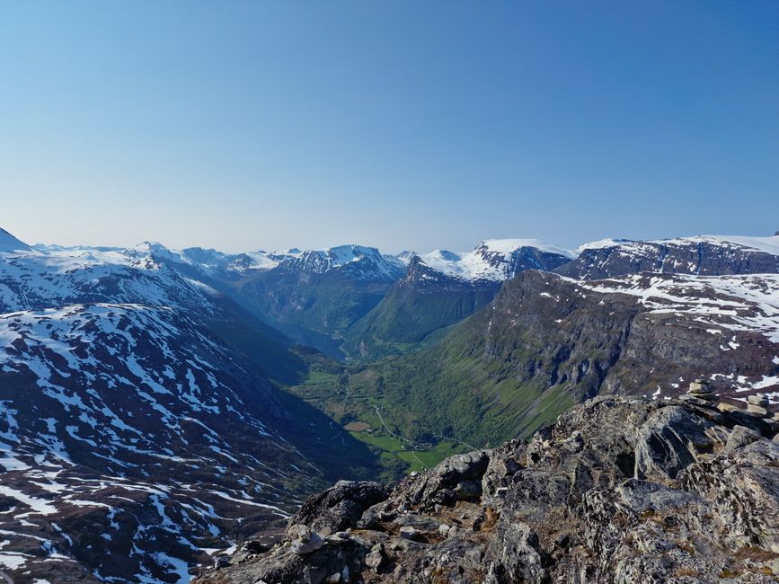 Amazing All-inclusive Northern Lights Hunt Review: An Unforgettable Norway Expedition Review 2026 - A stunning view of snowcapped mountains and a lush green valley under a clear blue sky.