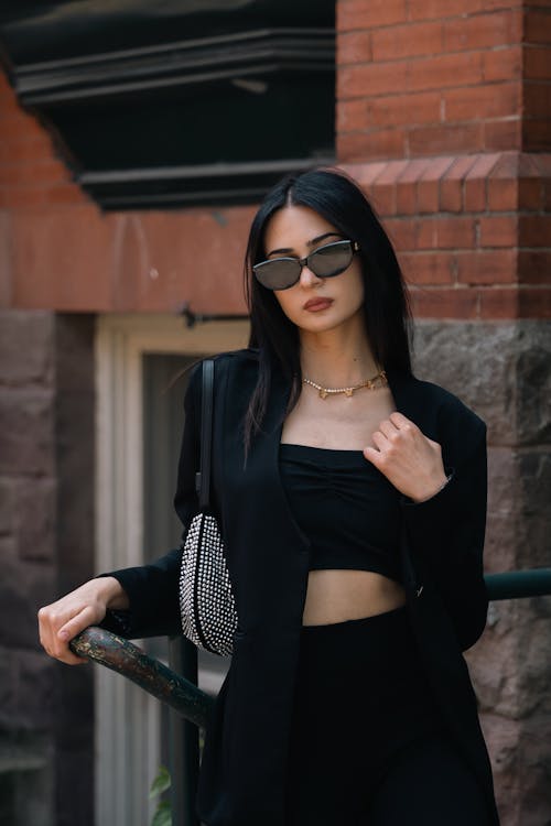 Woman in Black Clothing Leaning on Handrail