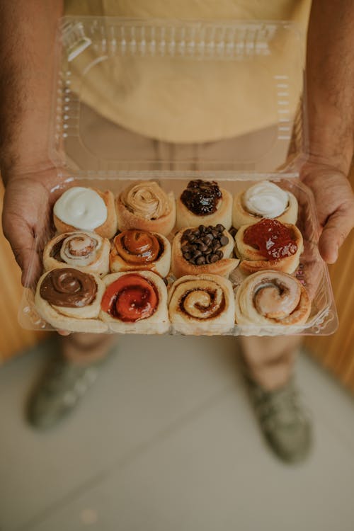 Hands Holding Box with Cakes