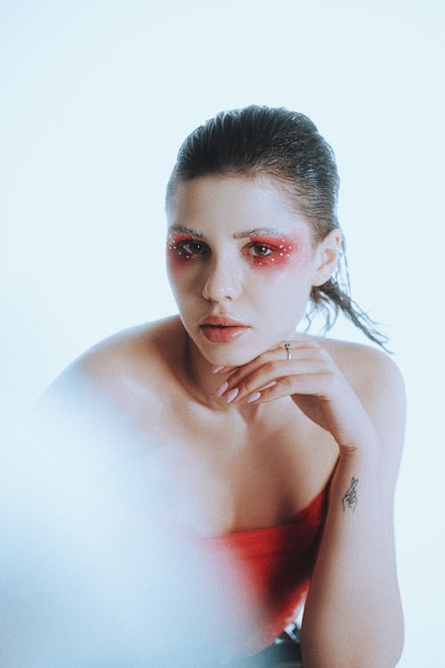 Photo of a Young Woman with Red Makeup