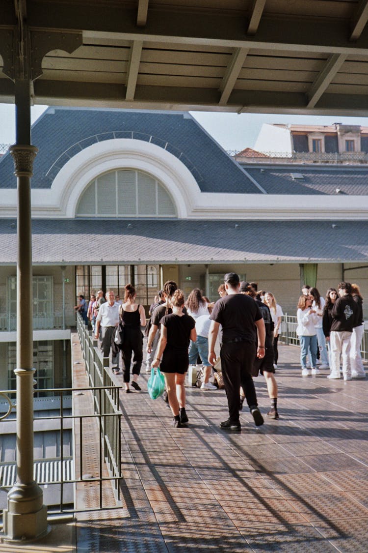 People Walking Towards Building