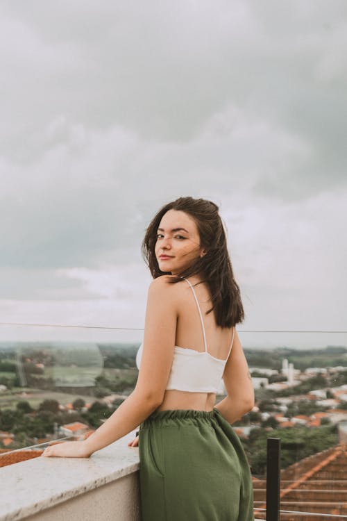 Young Woman in a Casual Outfit Posing on a Terrace